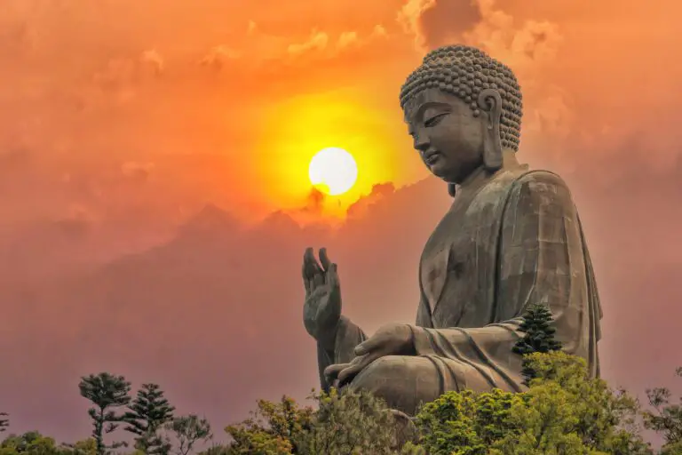 Bronze Buddha statue against the sunset. Meditationair.com