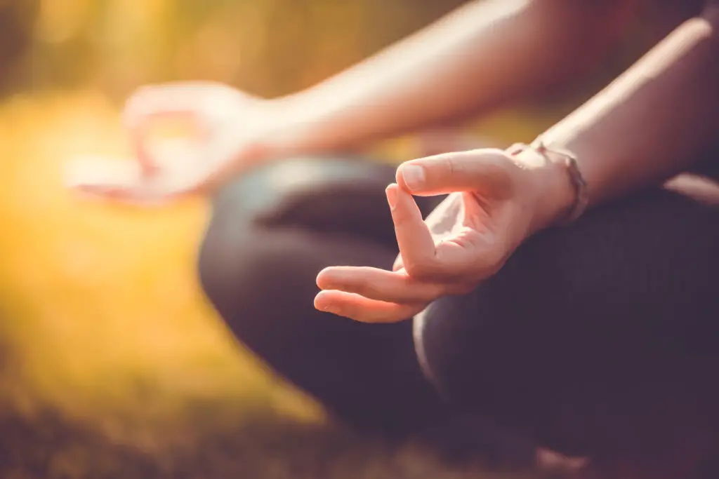 Person in meditation, with hands in the Chin or Gaya Mudra. How to do yoga meditation.